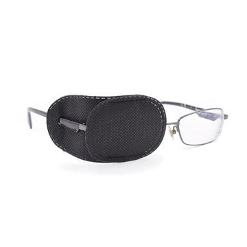 A photo of a black eye patch fitted around a lens on a pair of glasses.