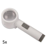 White, round lens stand magnifier with cylindrical handle grey on/off switch and grey battery port. 5x.