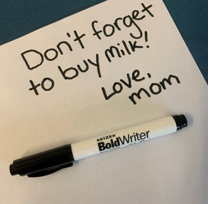 The Reizen BoldWriter 20 laying on a sheet of paper reading "Don't forget to buy milk! Love, Mom" to show bold, high contrast.