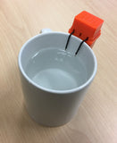 Top view of mug with liquid level indicator hanging from rim. 