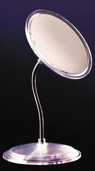 Round magnifying mirror on a silver stand with silver circular base on black background.