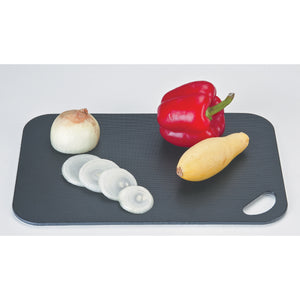 Cutting board shown with the black side up with onions, peppers and squash on top to show contrast