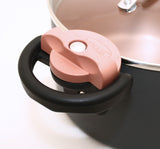 Image of copper colored locking mechanism on the side of the pot  shown in the locked position.